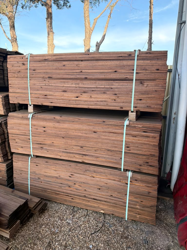 Outdoor stacked cedar fence boards pre-stained